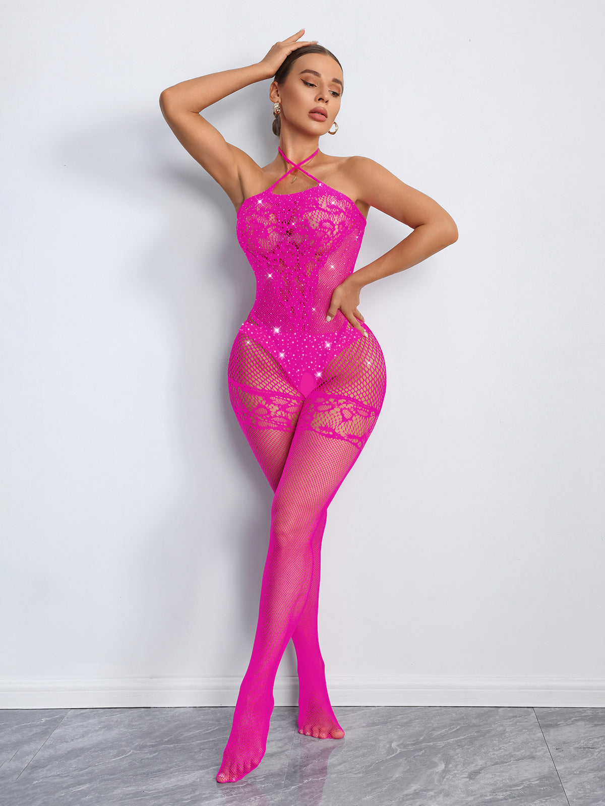 Model wearing a bright pink bodystocking against a white background
